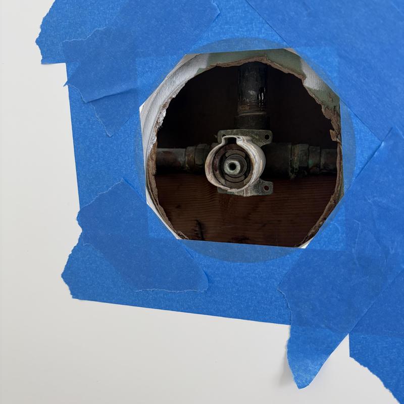 Shower valve rough-in behind drywall with blue tape Shower valve rough-in behind drywall with blue tape