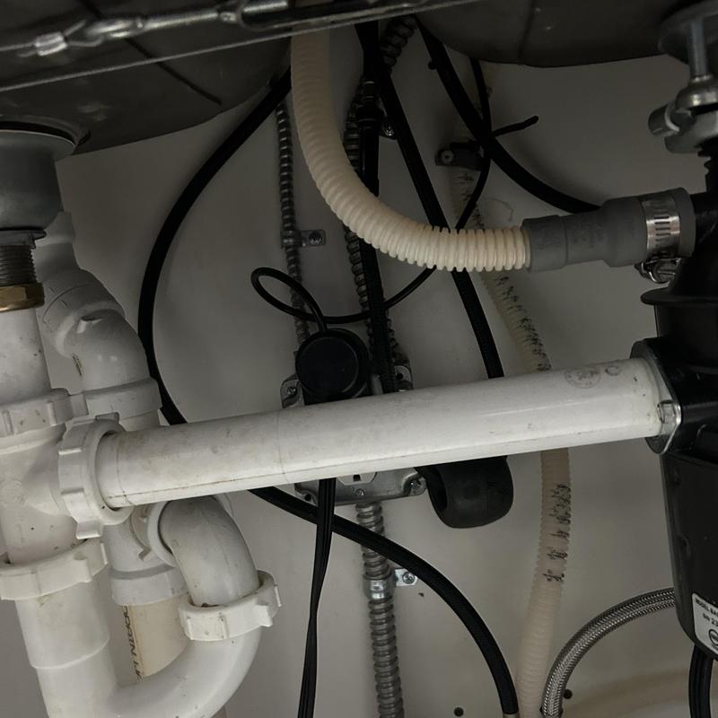 Kitchen sink drain pipes with connected plumbing under cabinet Kitchen sink drain pipes with connected plumbing under cabinet