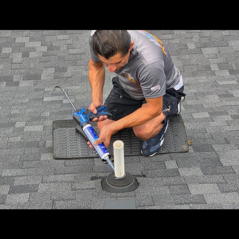 Pipe boot sealing on gray shingle roof in Spartanburg