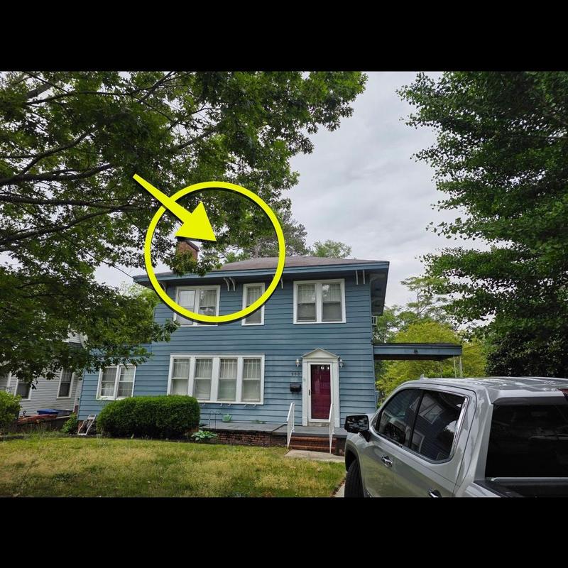 Chimney inspection on blue two-story house