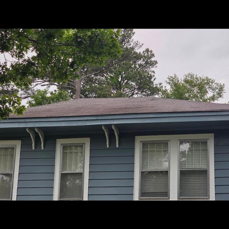 Architectural shingle roof on blue house exterior