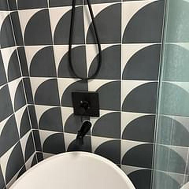 Tub spout installation with modern black fixtures