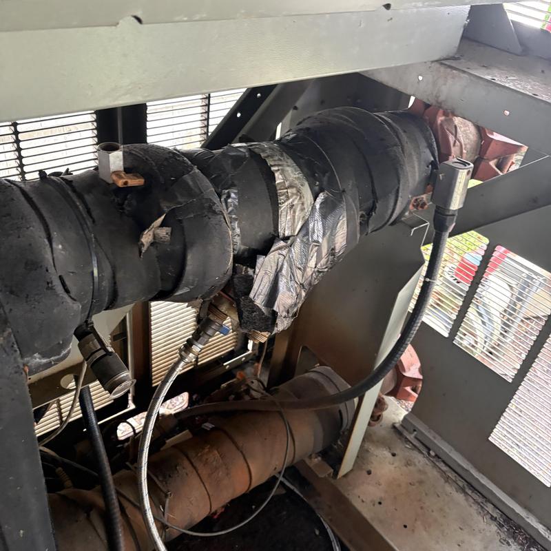 Insulated HVAC refrigerant lines with tape repairs Insulated HVAC refrigerant lines with tape repairs