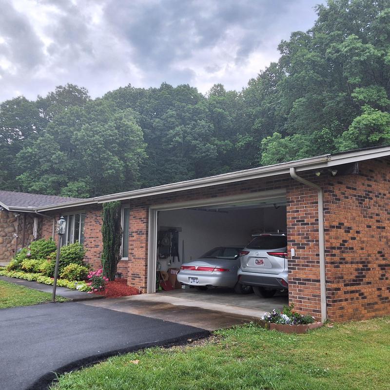 Asphalt shingle roof with visible wear and algae growth Asphalt shingle roof with visible wear and algae growth