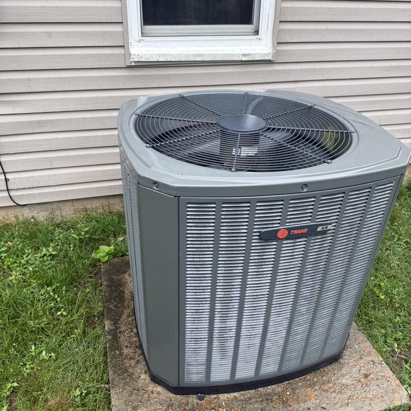Split heat pump outdoor unit on concrete pad Split heat pump outdoor unit on concrete pad