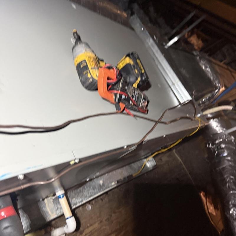 Split heat pump attic unit with tool on top Split heat pump attic unit with tool on top