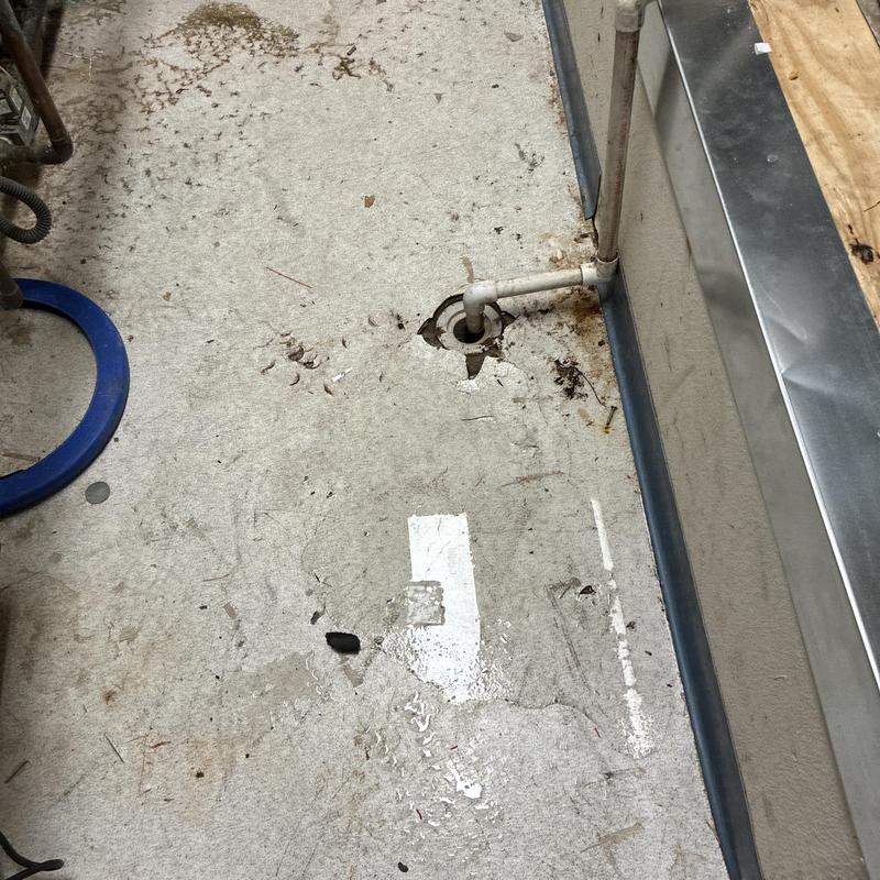 Floor drain with exposed pipe and wet floor Floor drain with exposed pipe and wet floor