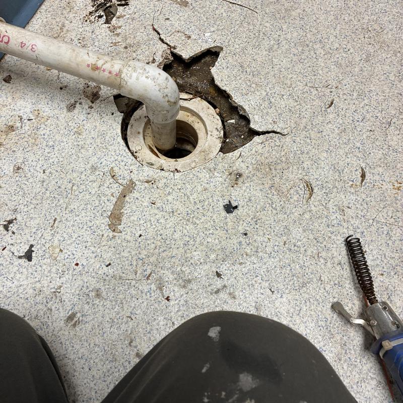 Floor drain with clogged pipe in utility closet Floor drain with clogged pipe in utility closet