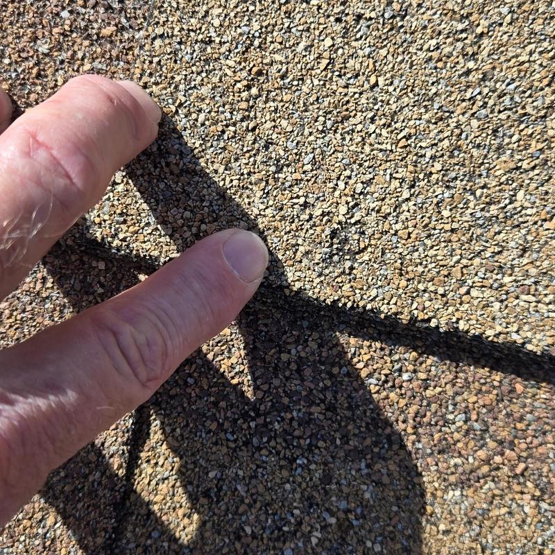 Roof shingles granule loss from hail damage close-up