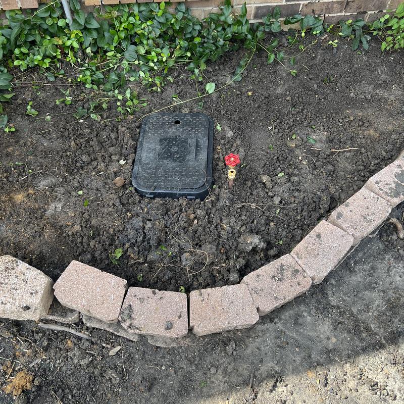Valve box and hose spigot installation in garden bed