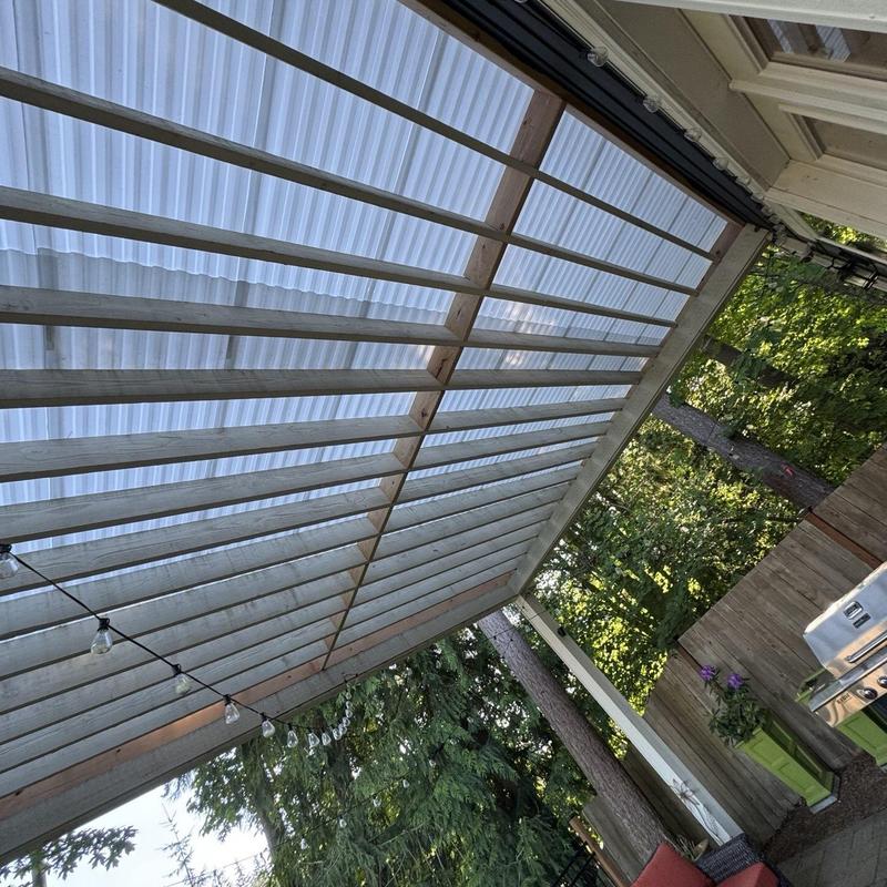 Patio roof with translucent corrugated panels and wood framing