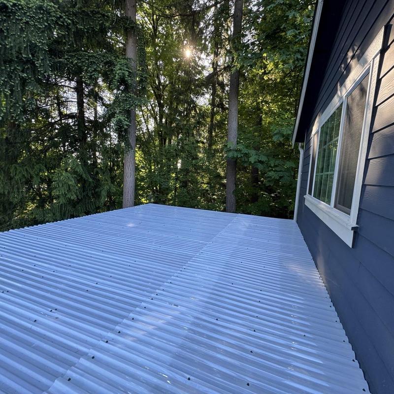 Corrugated metal patio roof next to blue house