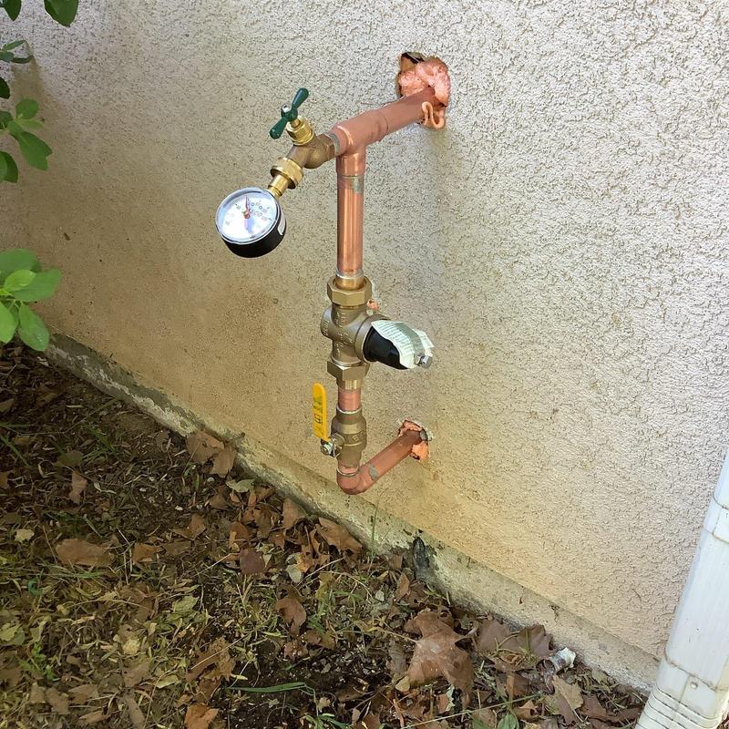 Water shutoff and pressure regulator valve installation outdoors