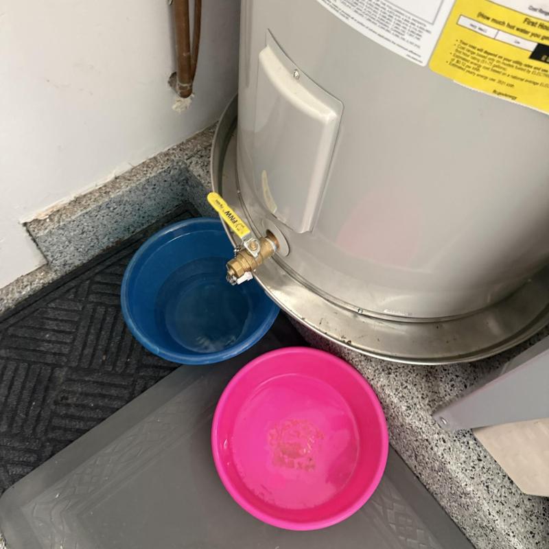 Water heater drain valve with buckets on floor