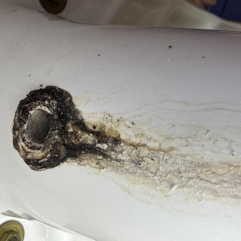 Toilet bowl leak with corrosion and mineral buildup