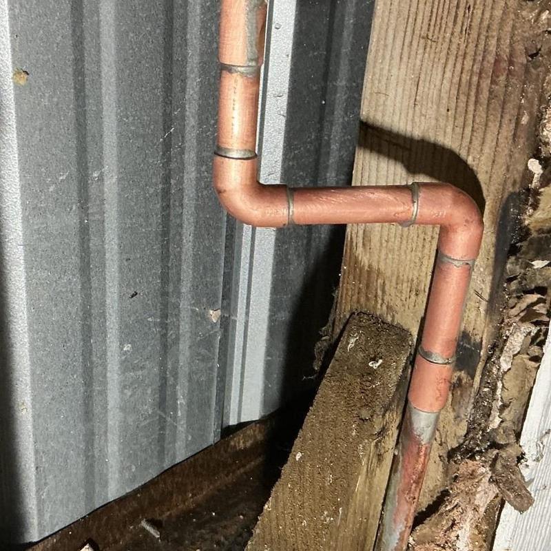 Copper piping with new Type L fittings near wooden beam