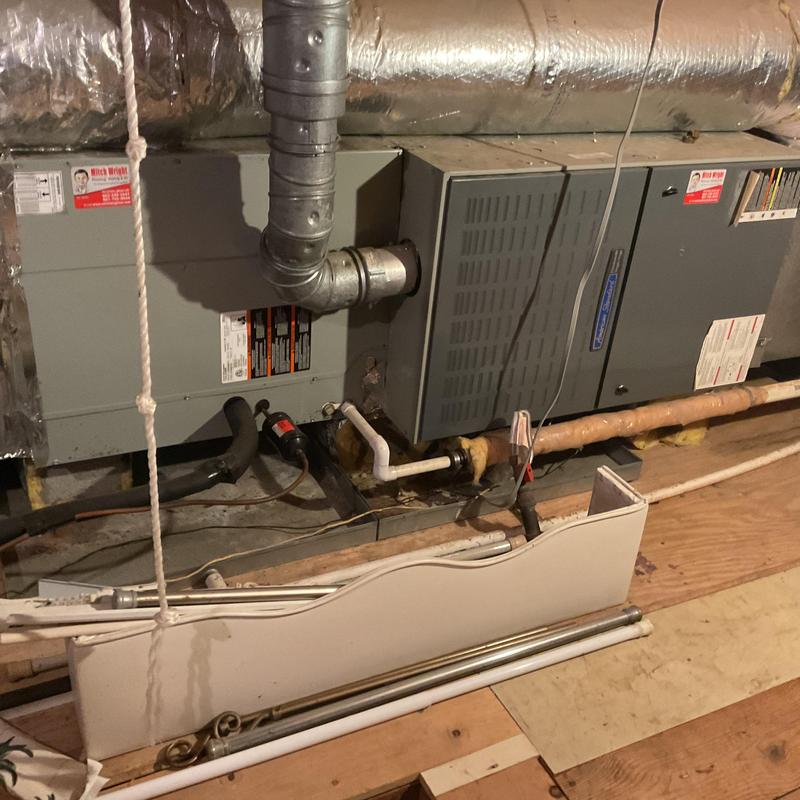 Furnace and duct system with vent and pipes visible Furnace and duct system with vent and pipes visible