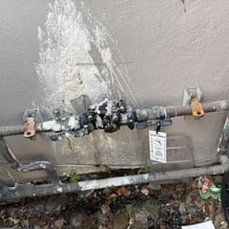 Backflow prevention device with pipe fittings outdoors