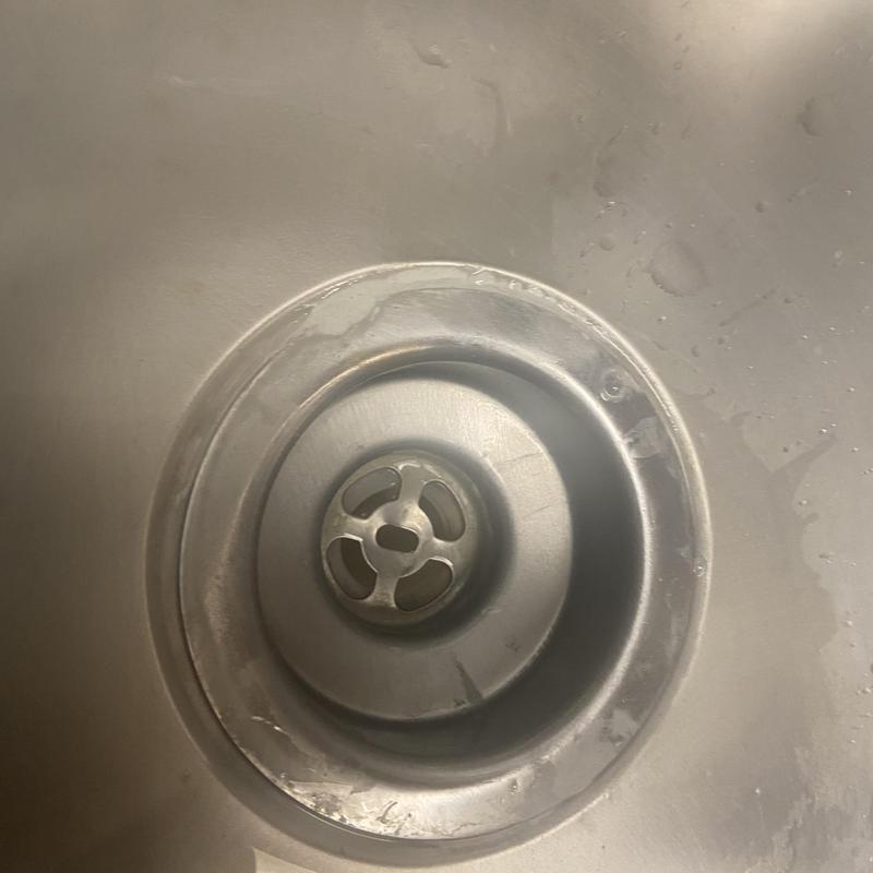 Kitchen sink basket strainer with water damage and seal issues