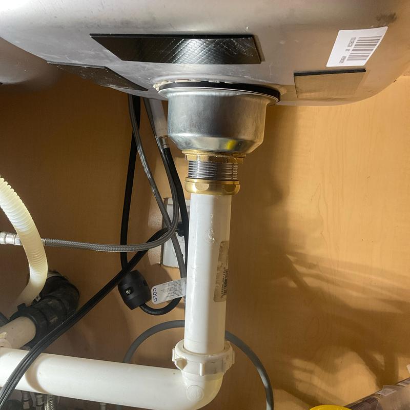 Basket strainer under kitchen sink with PVC drain pipe