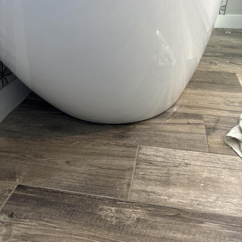 Freestanding bathtub base with new silicone sealant