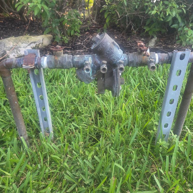 Backflow prevention assembly with exposed piping outdoors