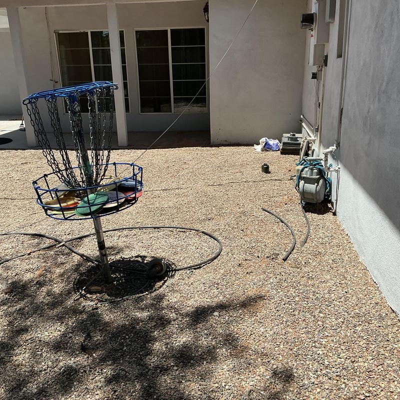 Main sewer line with exposed pipe and equipment outdoors