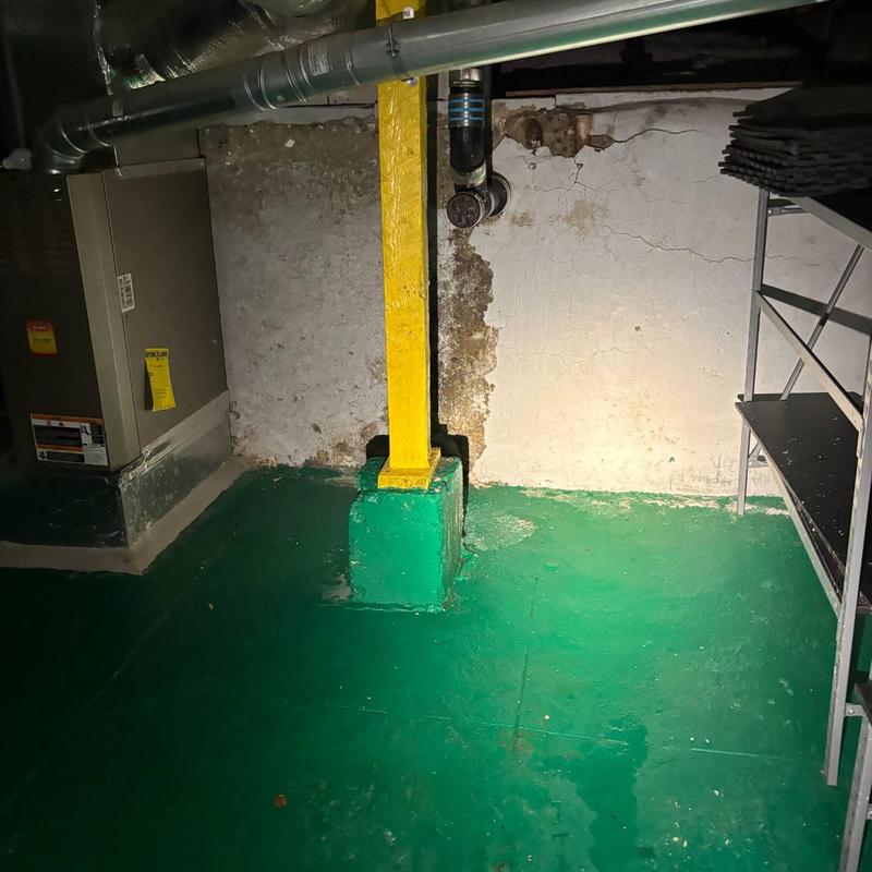 Basement main drain line with cleanout pipe and support post