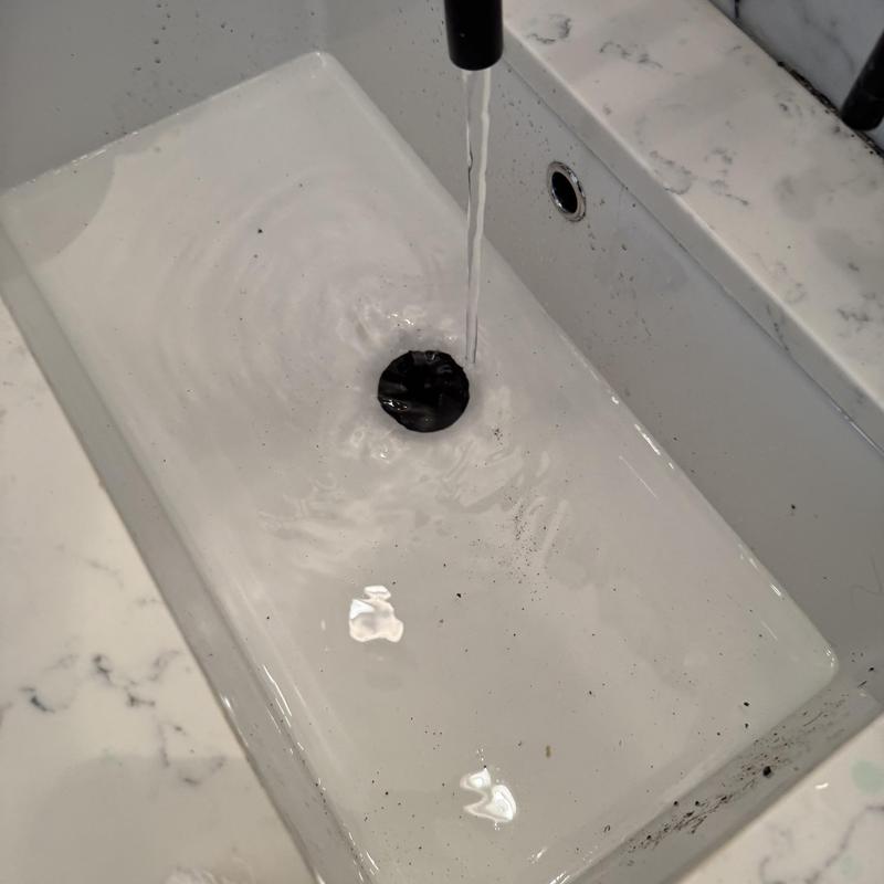 Basin drain flowing after hair clog removal service