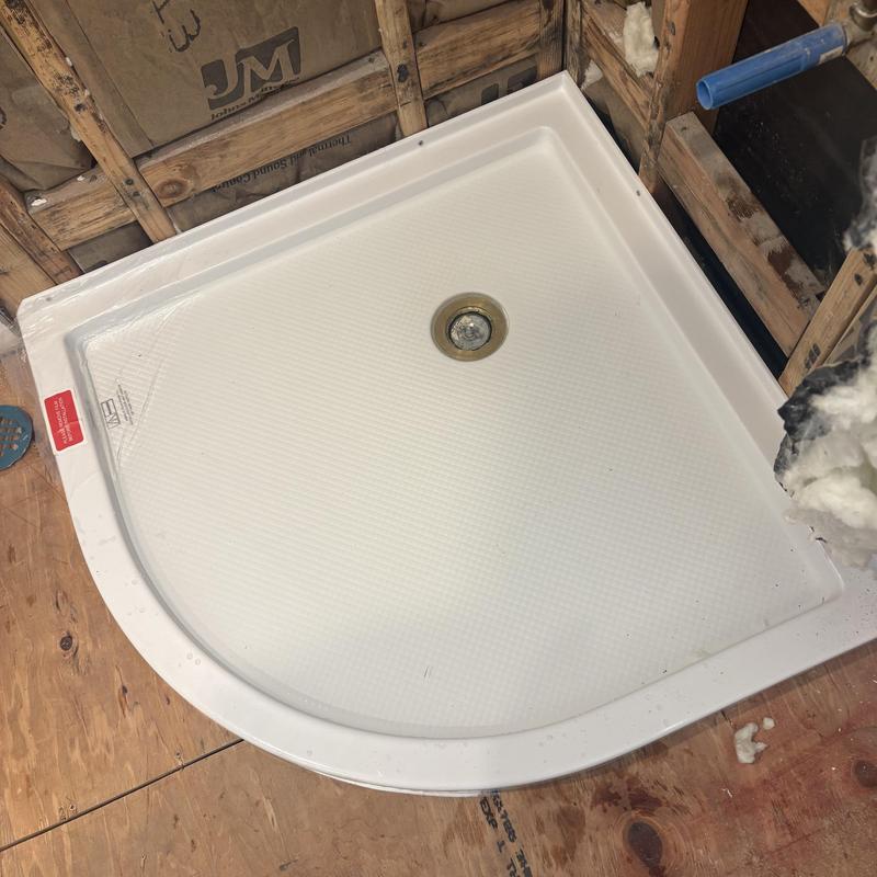 Shower pan installation with cast iron drain assembly