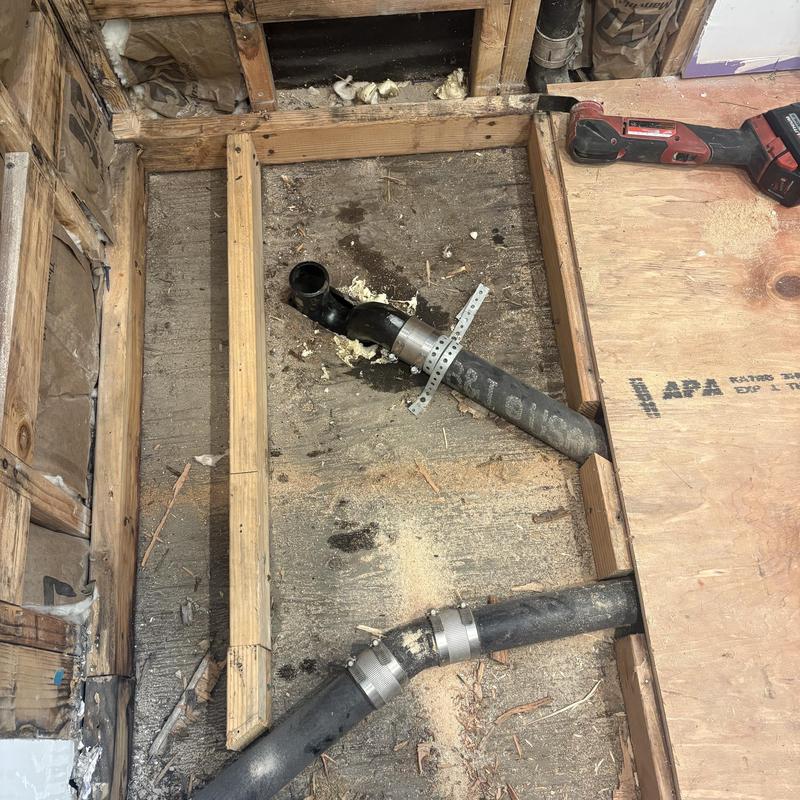 Cast iron P-trap and drain pipe installation in floor cavity