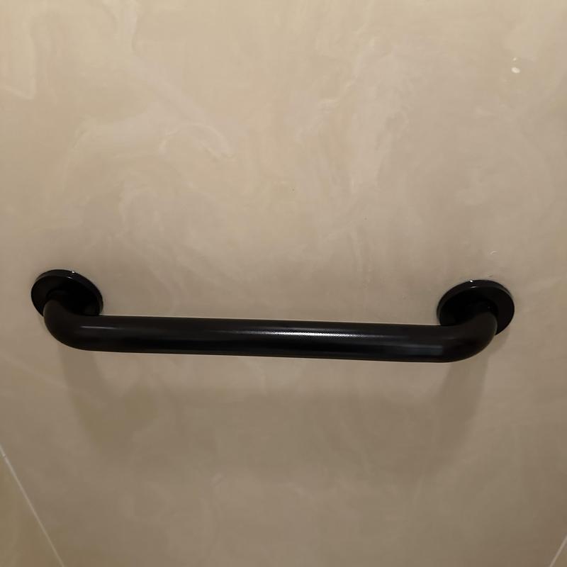 ADA grab bar installation on beige wall panel