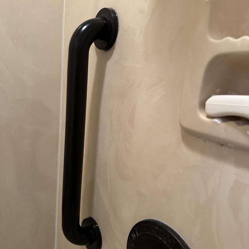 ADA grab bars installed in beige shower wall