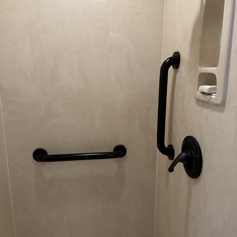 ADA grab bars installed in shower area