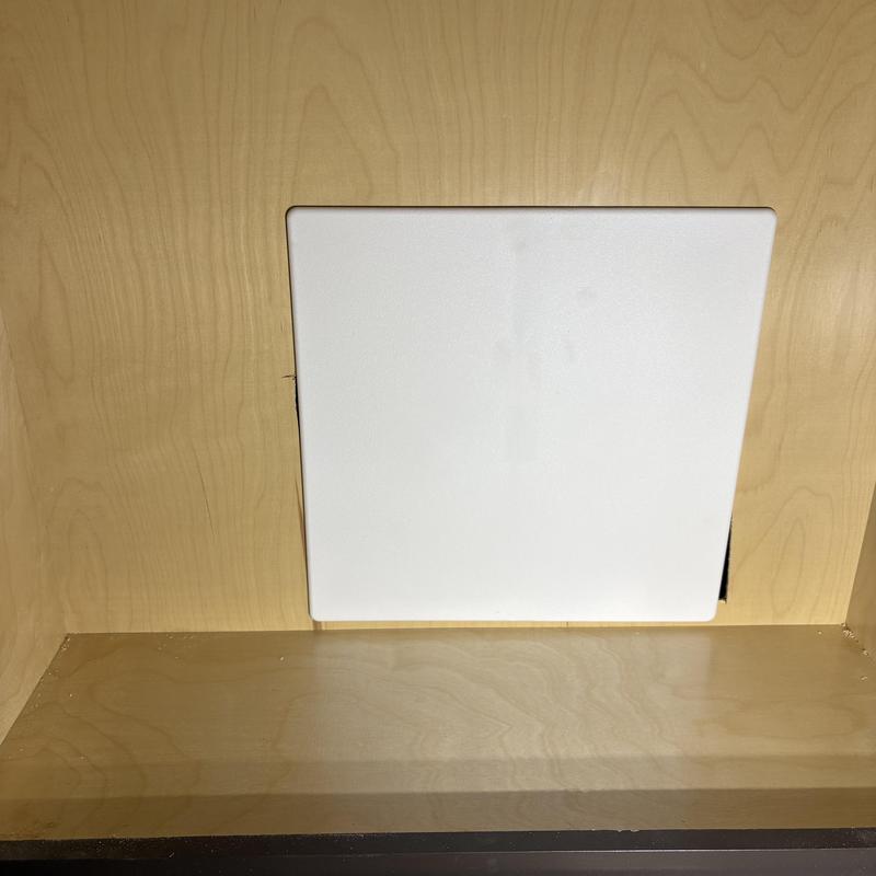 Manifold under kitchen sink with access panel installed