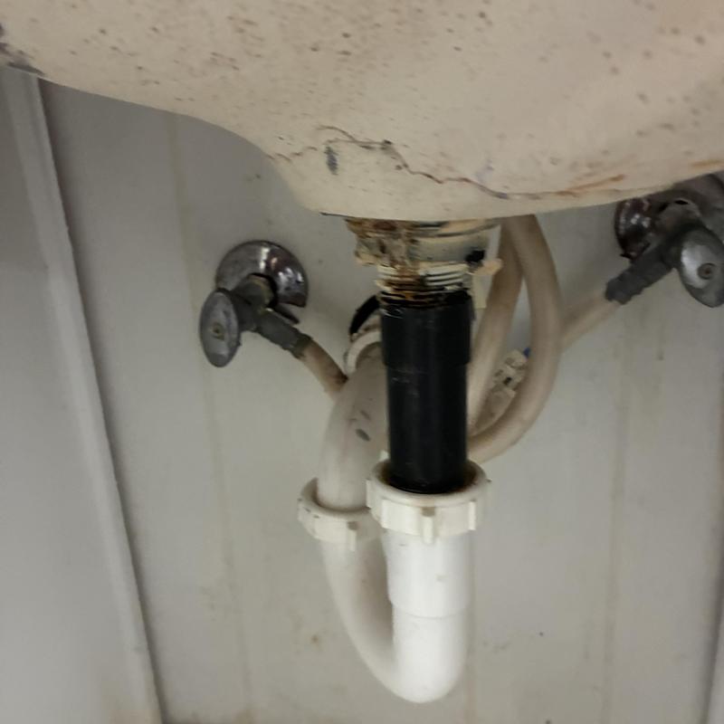 Bathroom sink drain pipe with rust and corrosion