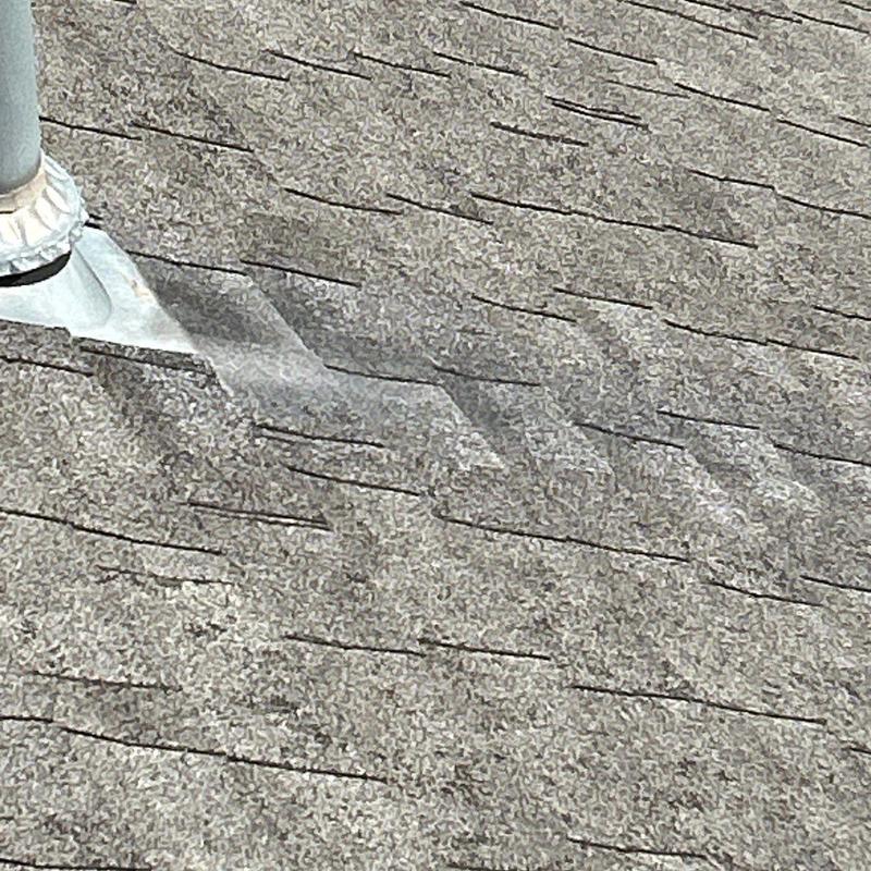 Roof flashing on shingle roof with hail damage