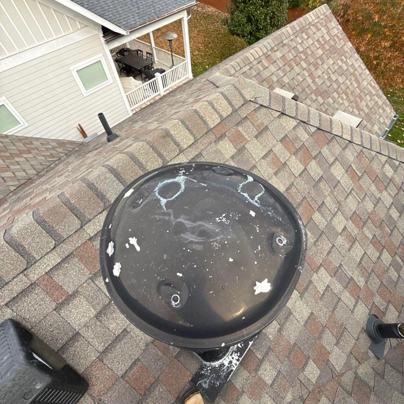 Ridge vent on shingle roof with hail damage marks