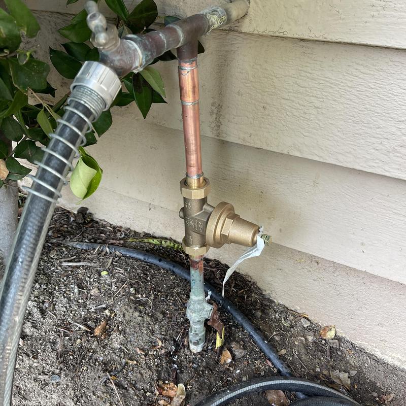 ZurnWilkins pressure regulator on copper pipe outdoors
