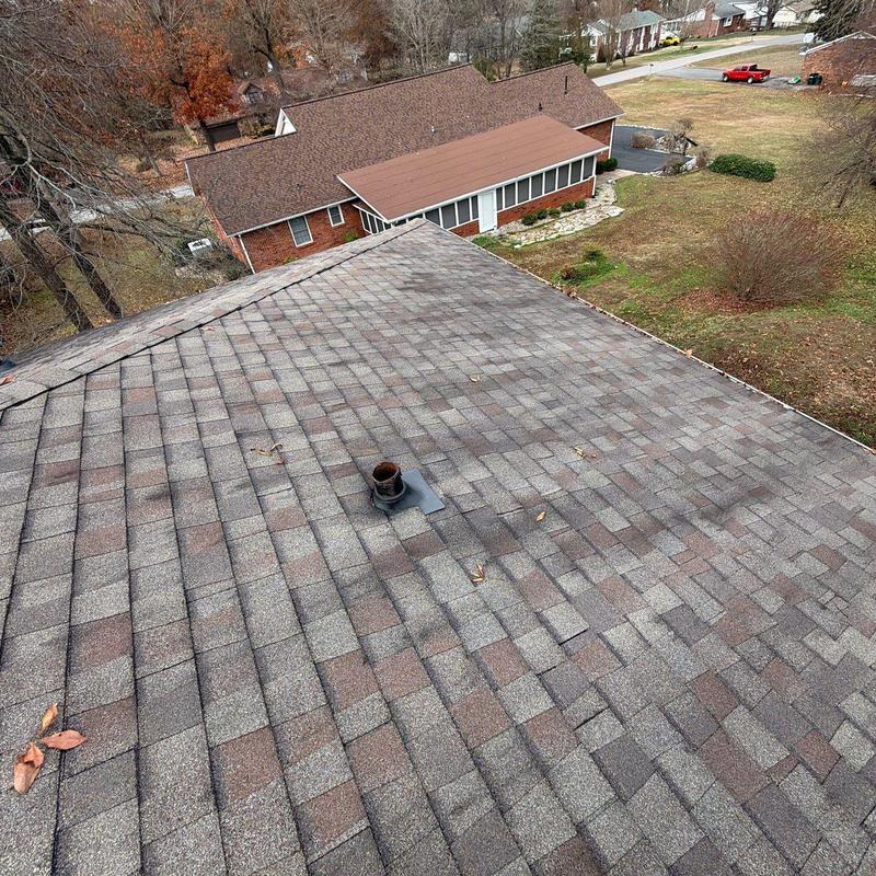 Asphalt shingle roof with vent pipe and hail damage
