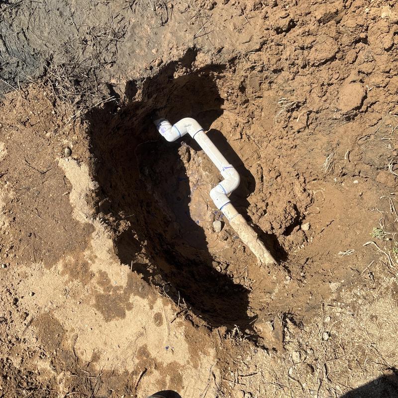 Outdoor hose bib PVC pipe installation in dirt hole