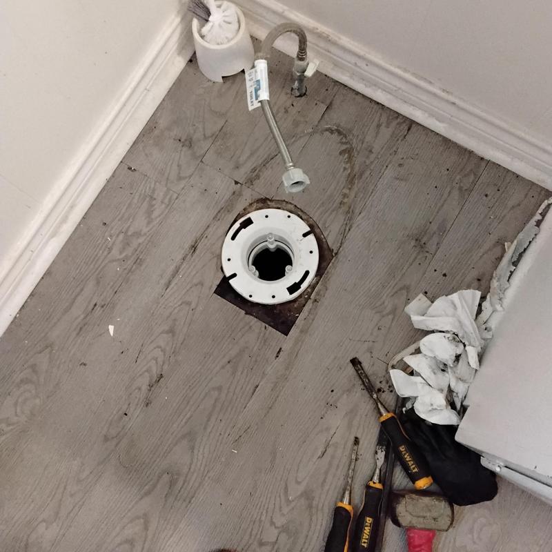 Toilet flange replacement with tools and fittings visible