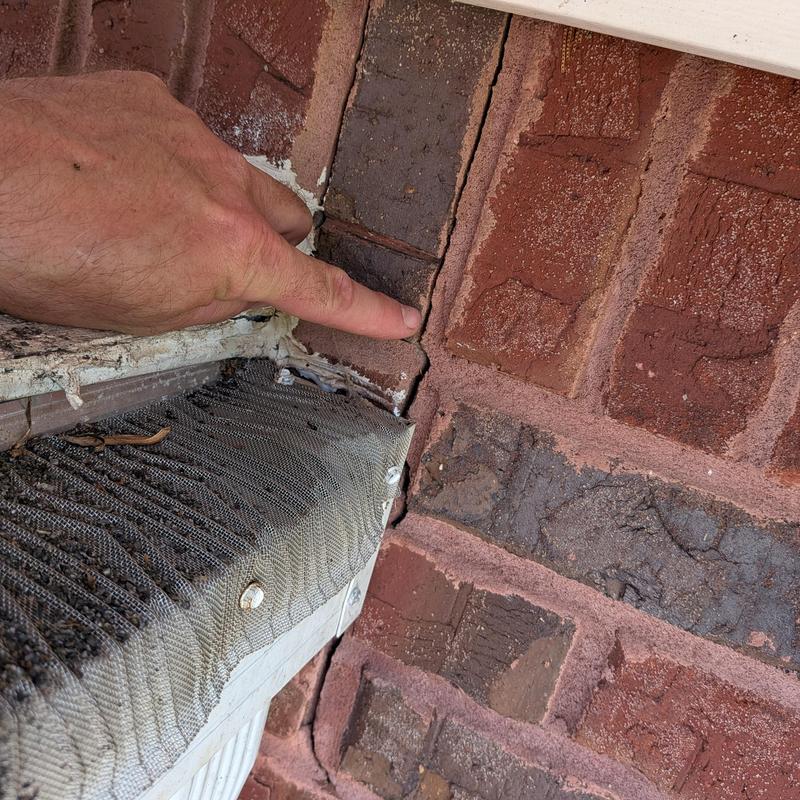 Brick wall joint leak inspection at house transition Brick wall joint leak inspection at house transition