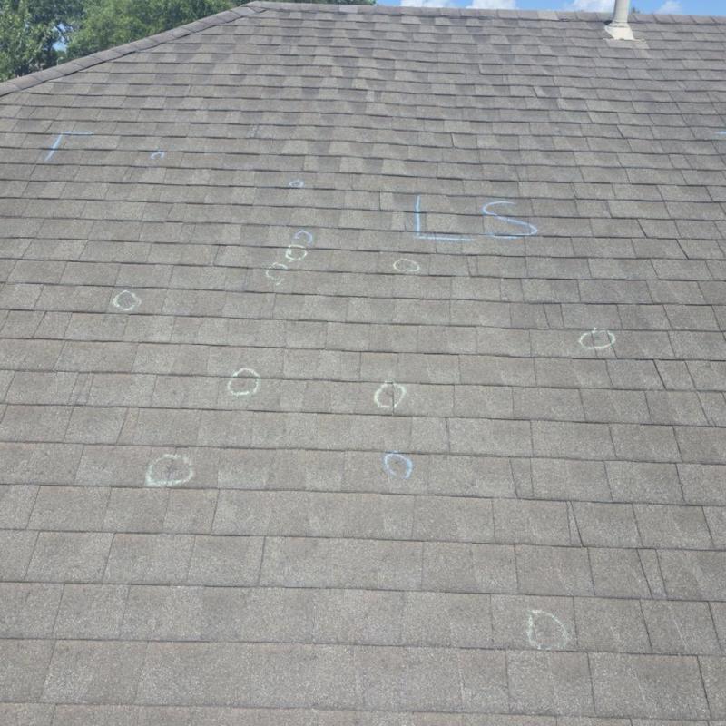 Architectural shingles with hail damage marks on roof