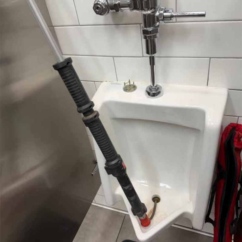 Urinal with auger clearing drain and flushometer sensor removed