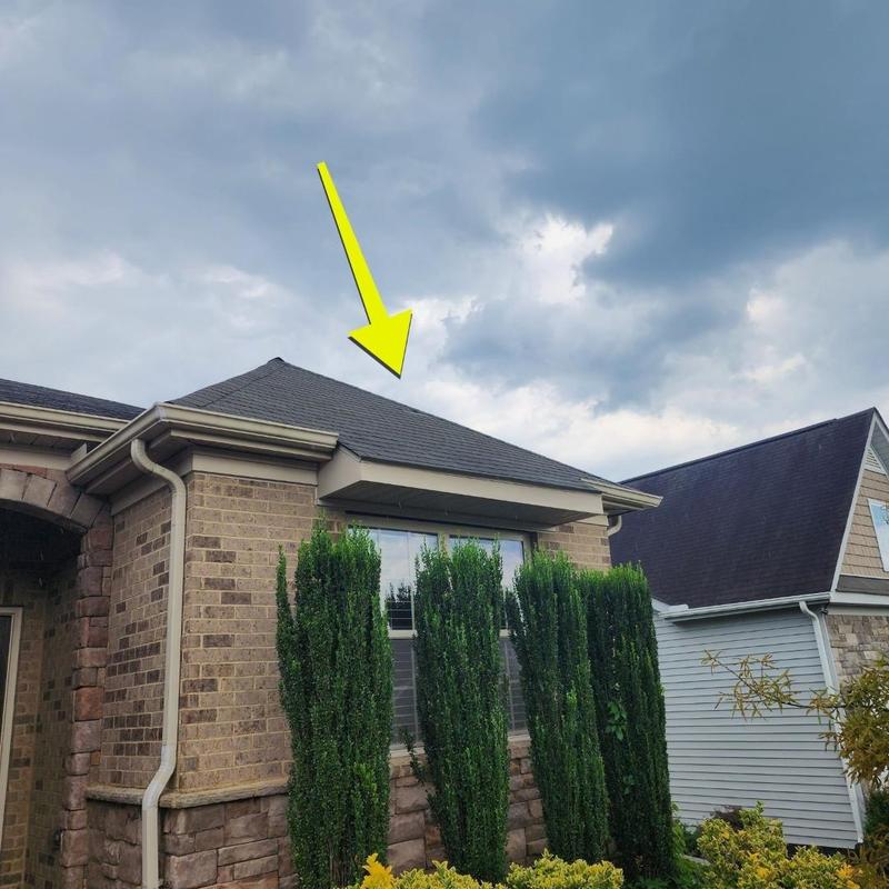 Asphalt shingle roof with storm damage and pipe boots