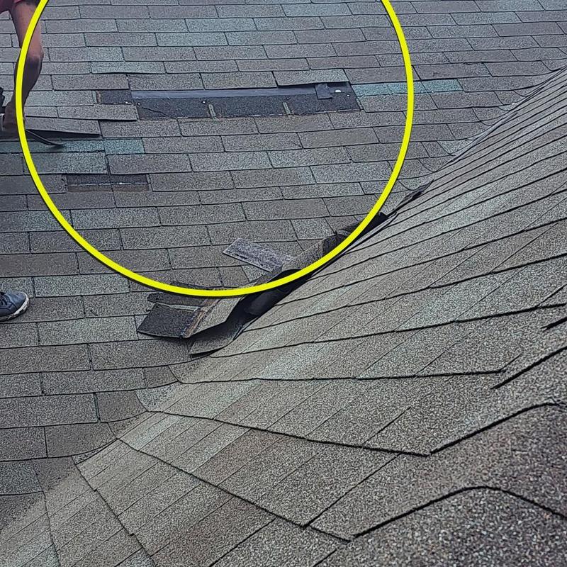 Roof shingles with storm damage and missing pieces