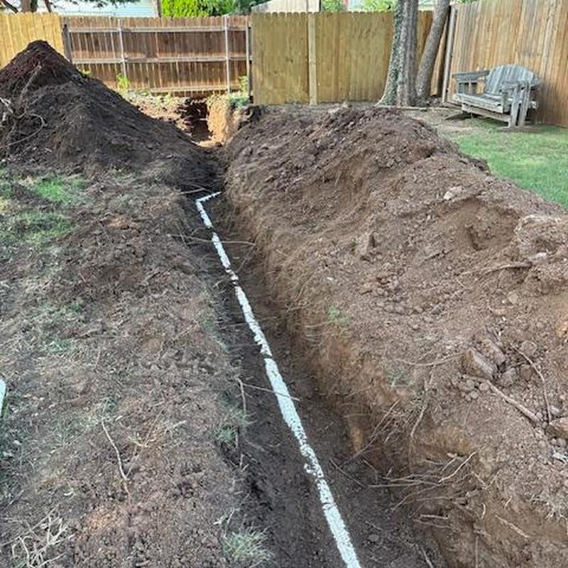 Sewer service line installation trench with pipe exposed Sewer service line installation trench with pipe exposed
