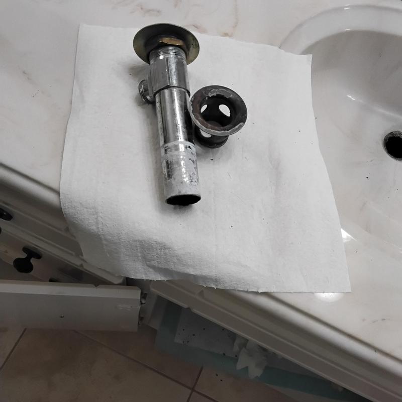 Pop-up drain assembly removed from bathroom sink