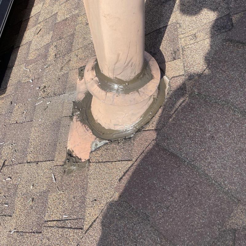 Roof vent flashing with fresh sealant on shingles